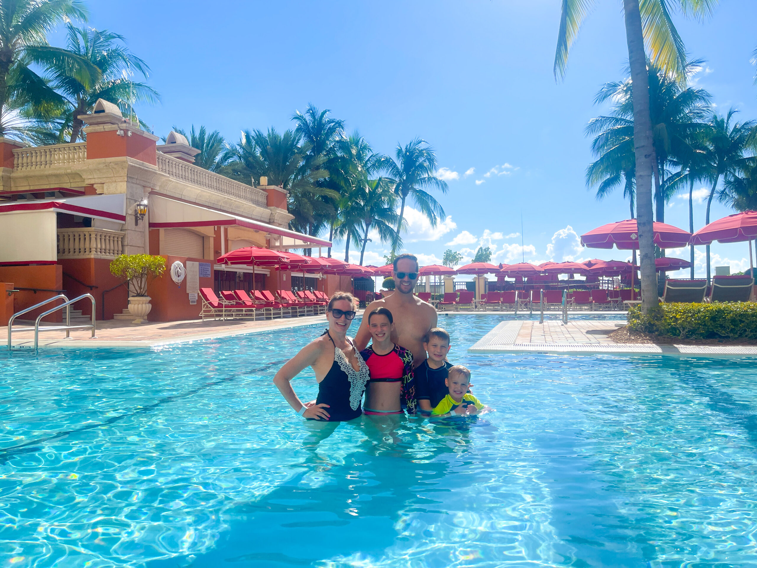 family in the pool at acqualina