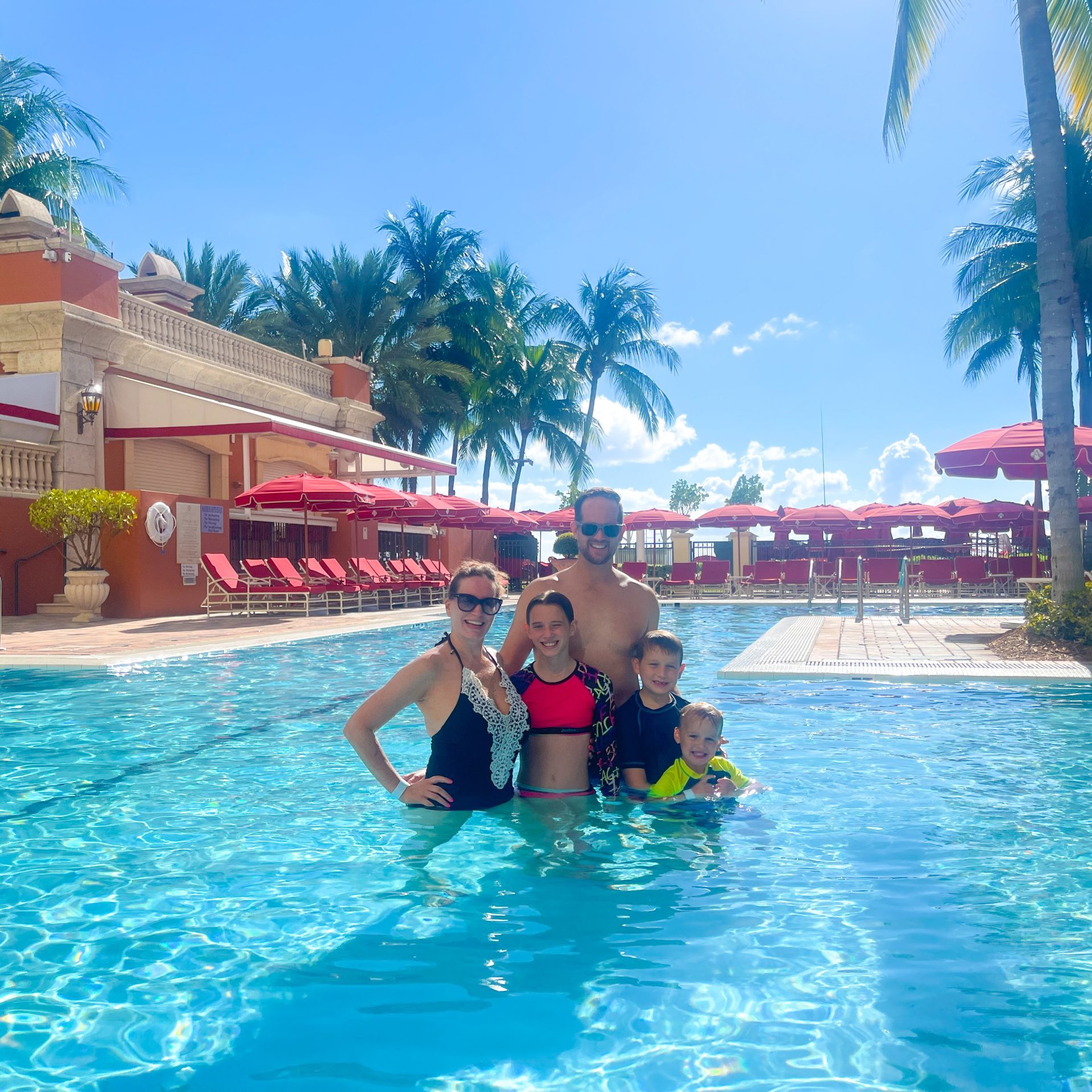 family in the pool at acqualina